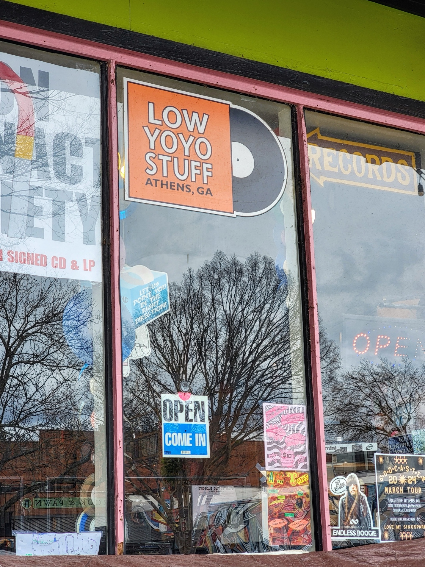 A storefront window with signs on it

Description automatically generated